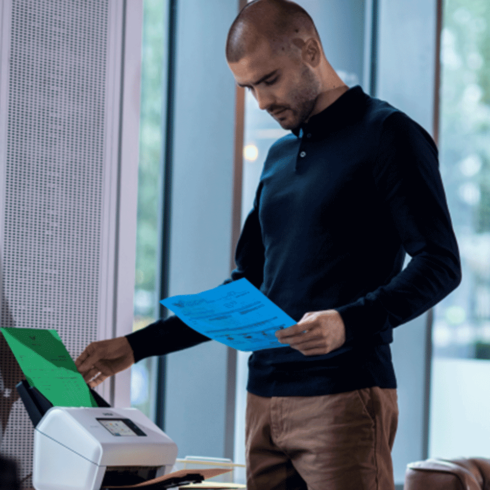 Man holding documents using ADS-4900W