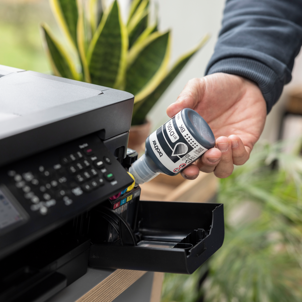 <p>Brother inkjet machine being filled using the BTD100BK black ink bottle</p>