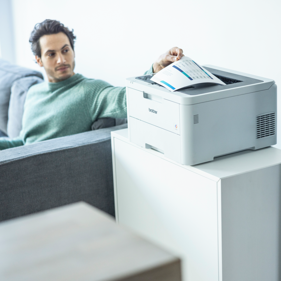 Man removing full colour duplex output from the HL-L3240CDW printer in a home setting