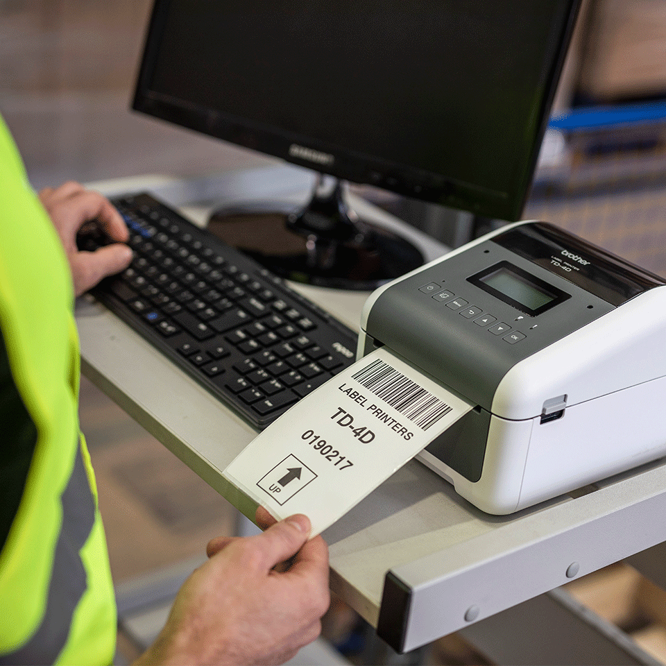 <p>The TD4455DNWB label printer in a warehouse work desk printing label. </p>