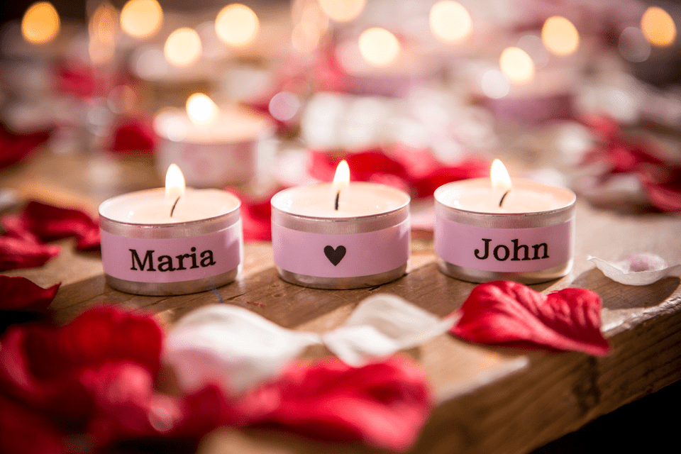 Brother TZe-MQE31 matt laminated tape cassette - black on pastel pink - tea lights in a romantic setting labelled with the names "Maria" and "John"