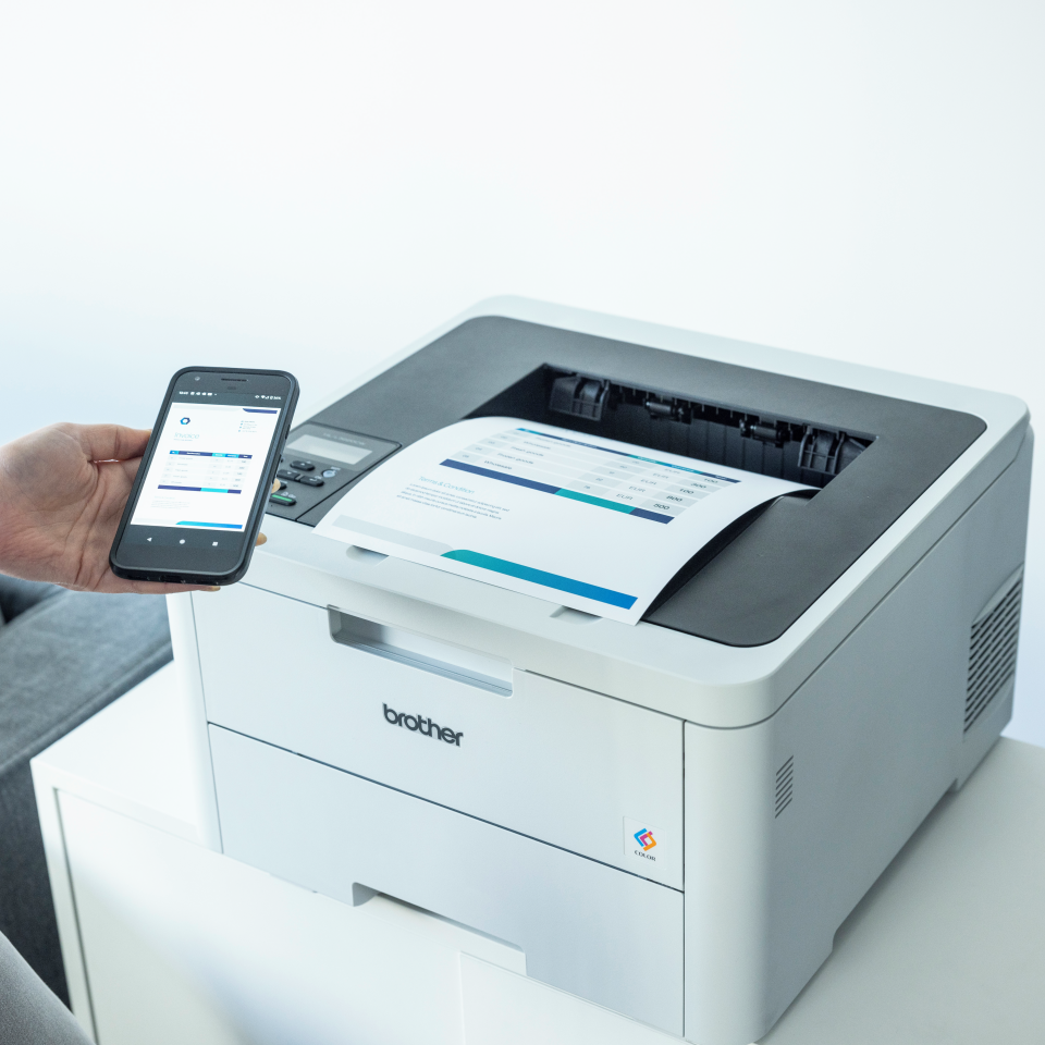 Brother HL-L3215CW colour LED printer being used with a mobile phone