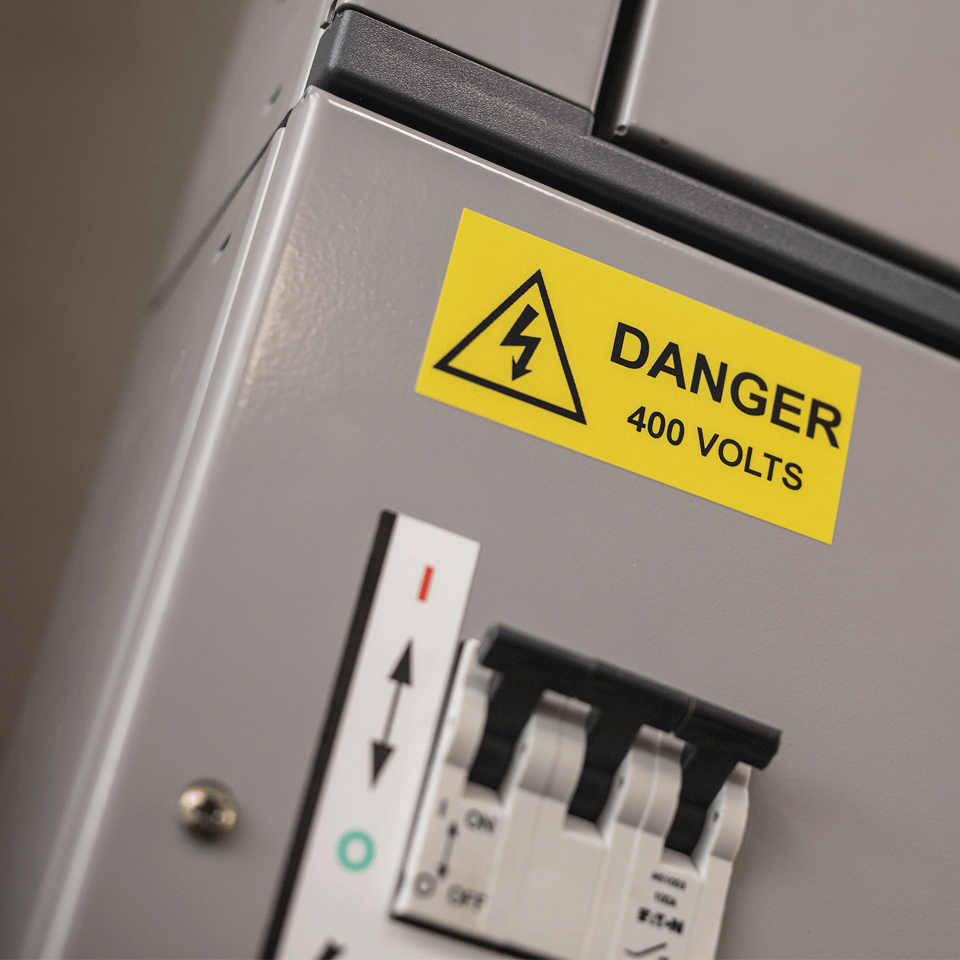 Danger 400 volts label applied to electrical unit using black on yellow strong adhesive TZe tape 