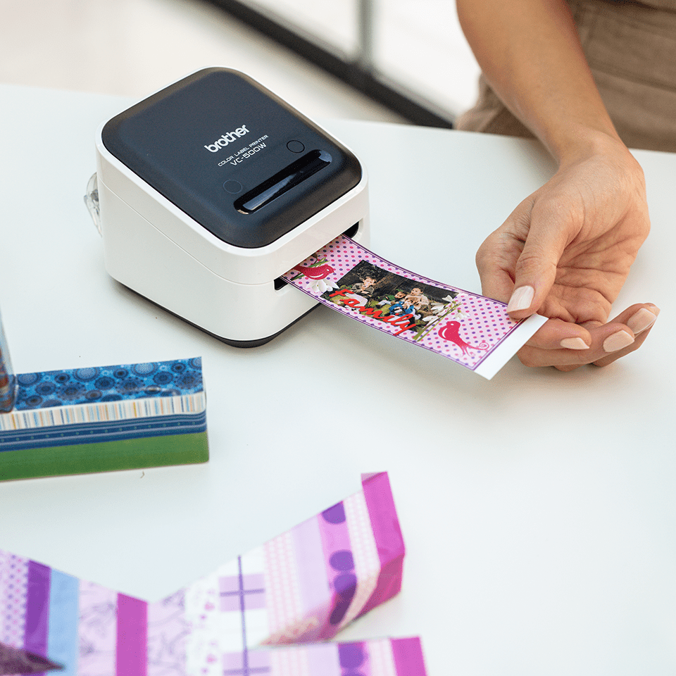 A Brother Design and Craft label printer printing a full colour label