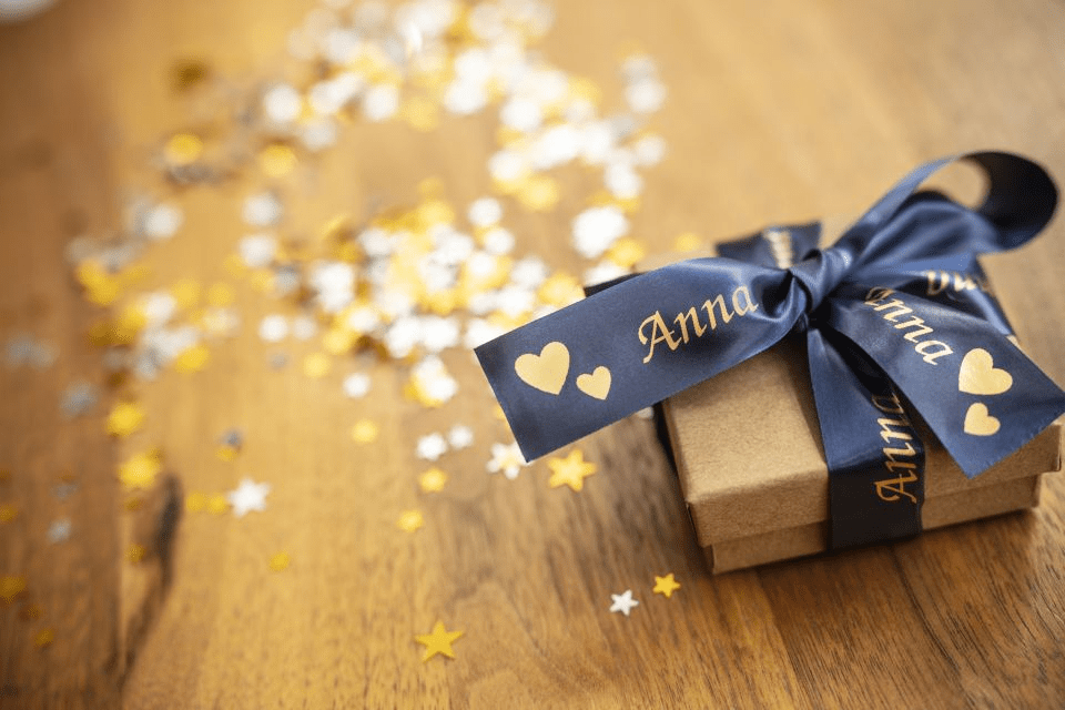 Brother TZe-RN54 satin ribbon tape cassette - gold on navy blue - gift box wrapped in a personalised ribbon