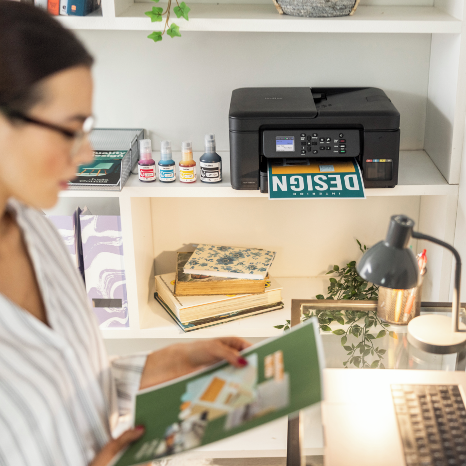 Woman reviewing colourful outputs