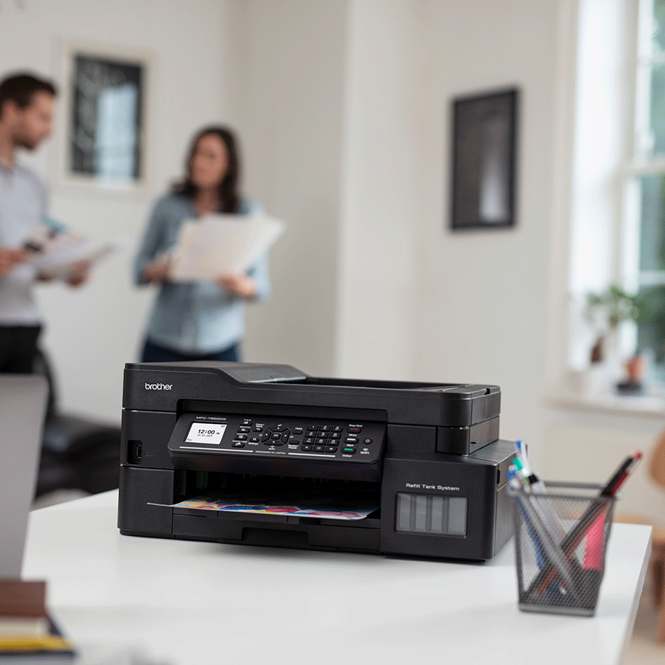 Man and woman working at home with printer visible