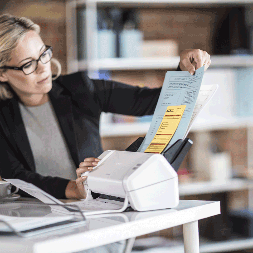Brother ADS-2200 desktop document scanner with female office worker