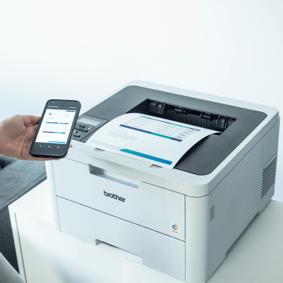 Brother HL-L3220CW colour LED printer being used with a mobile phone