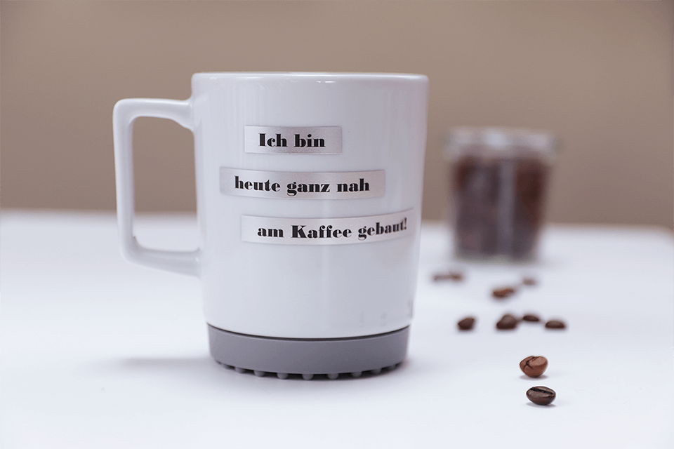 Brother TZe-M921 matt laminated tape cassette - black on silver - coffee cup labelled with German message "I am very close to the coffee today!"