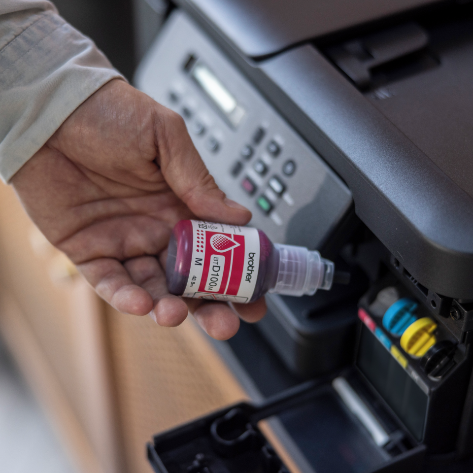 <p>Brother inkjet machine being filled using BTD100M magenta ink bottle</p>