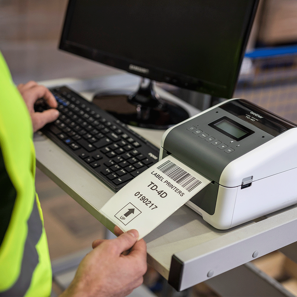 Brother TN-4550DNWB desktop label printer in warehouse printing shipping label
