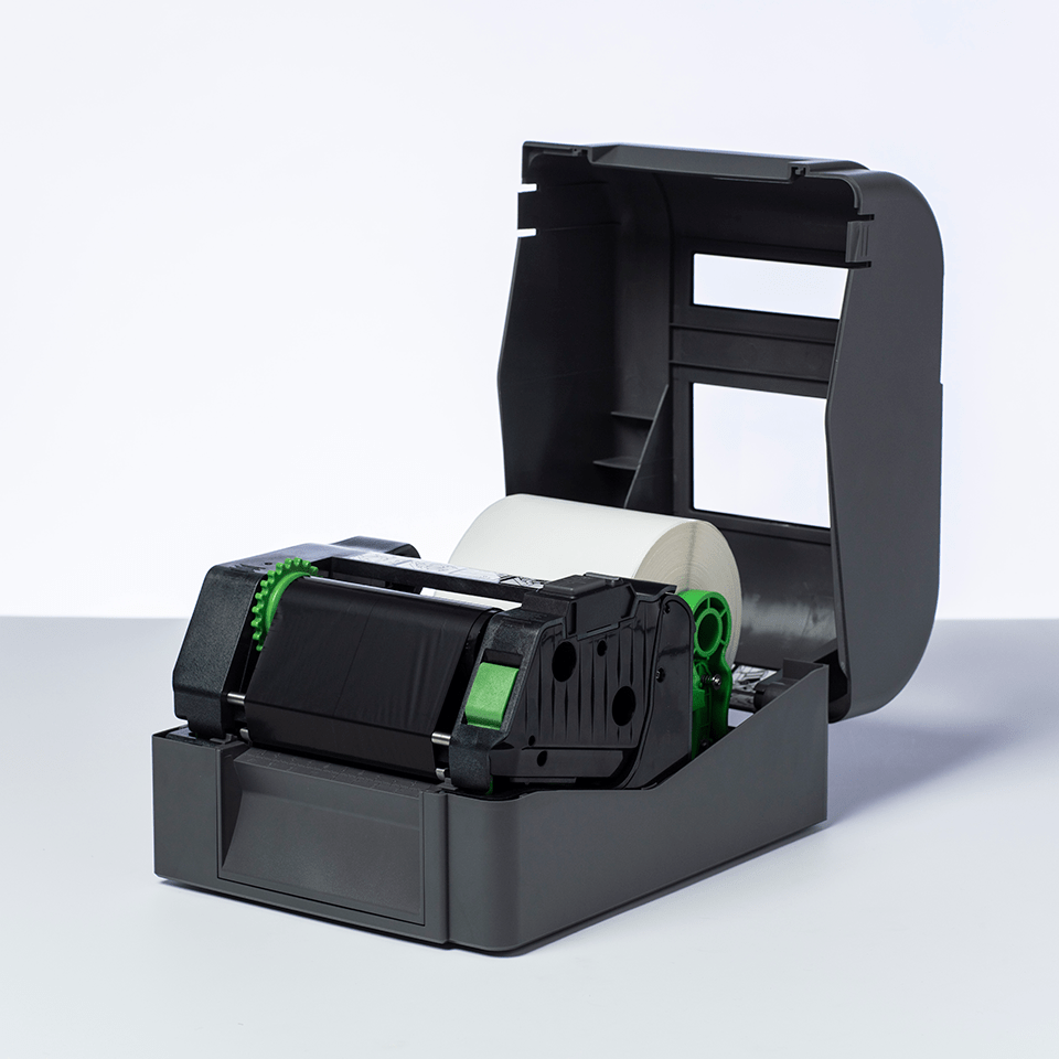Black thermal transfer ribbon roll in TD label printer with labels