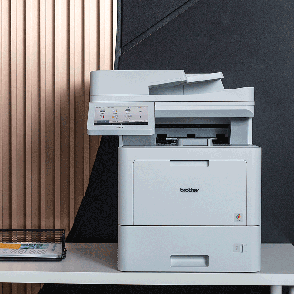 MFC-L9630CDN printer on white table, copper wall, document holder, colour documents