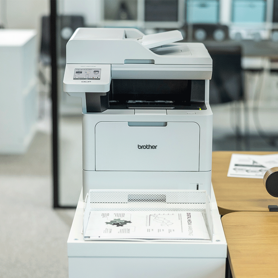 Brother MFC-L5715DN on white cabinet in office, mono documents