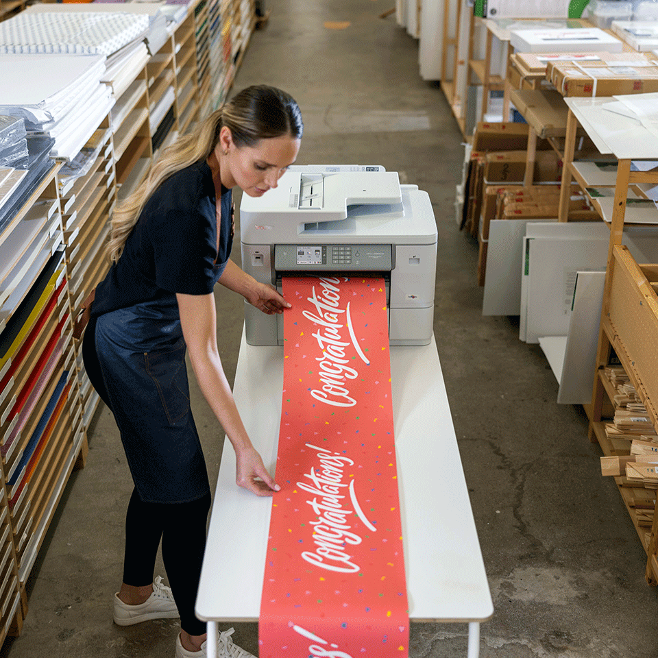 Woman printing very large format banner on MFCJ6959DW