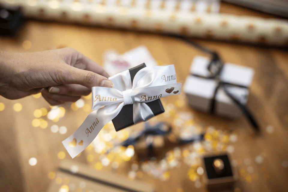 Brother TZe-R254 satin ribbon tape cassette - gold on white - gift box wrapped in a personalised ribbon