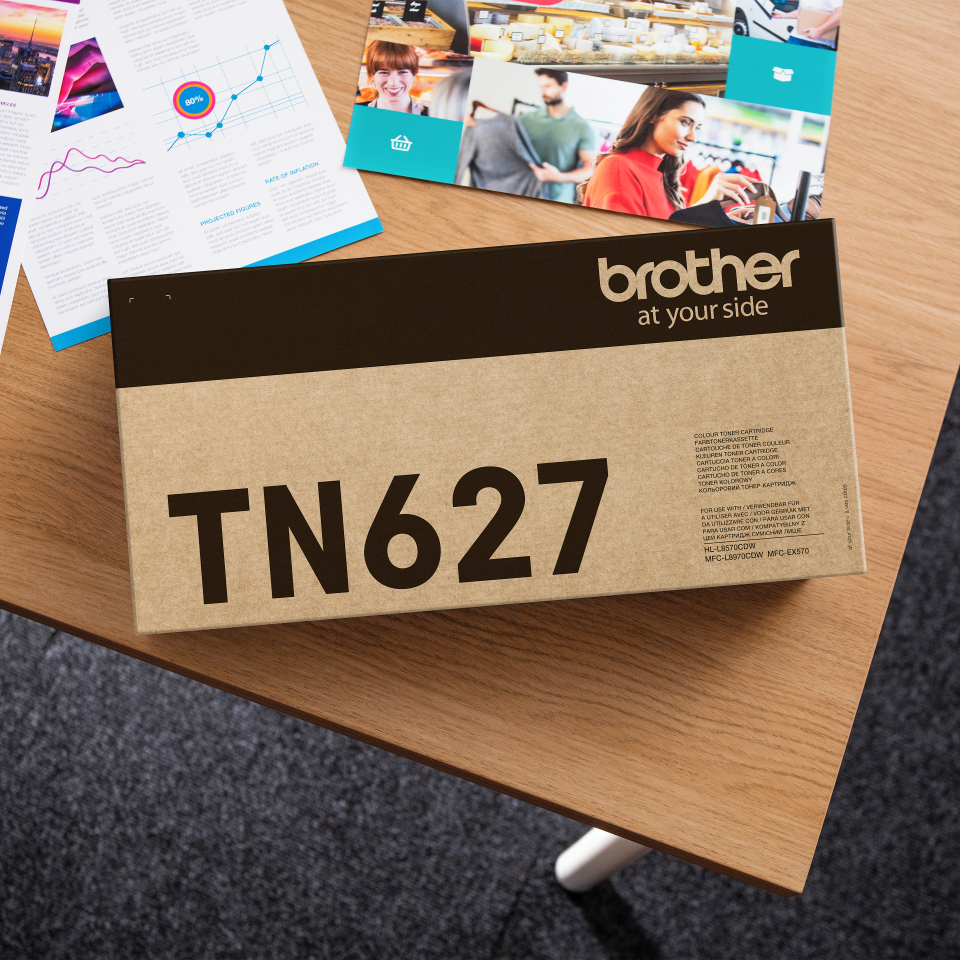 <p>Brother TN627Y yellow toner carton on a desk</p>