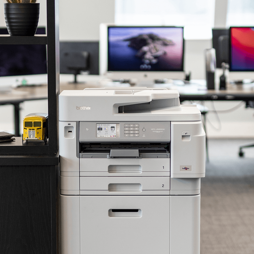 Business printer on cabinet in office, chairs, monitors