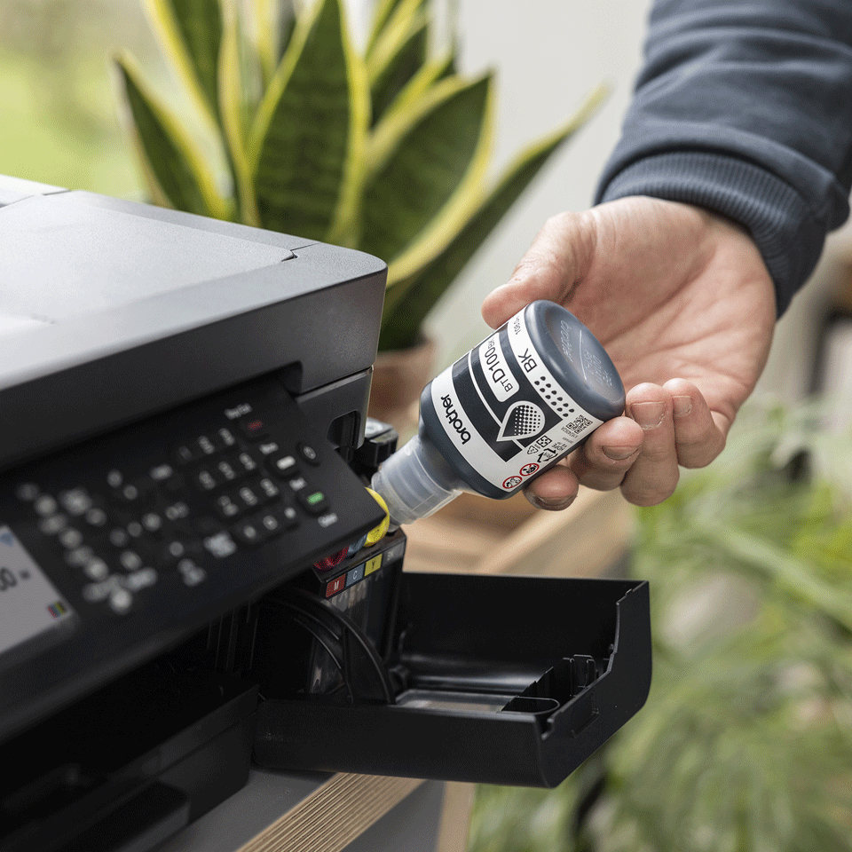 <p>BTD100BK ink bottle being used to fill the MFCT930DW</p>