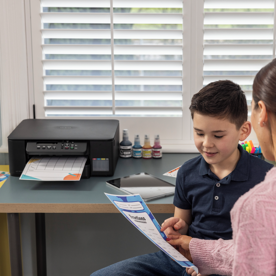 <p>Child and woman reviewing colourful outputs</p>