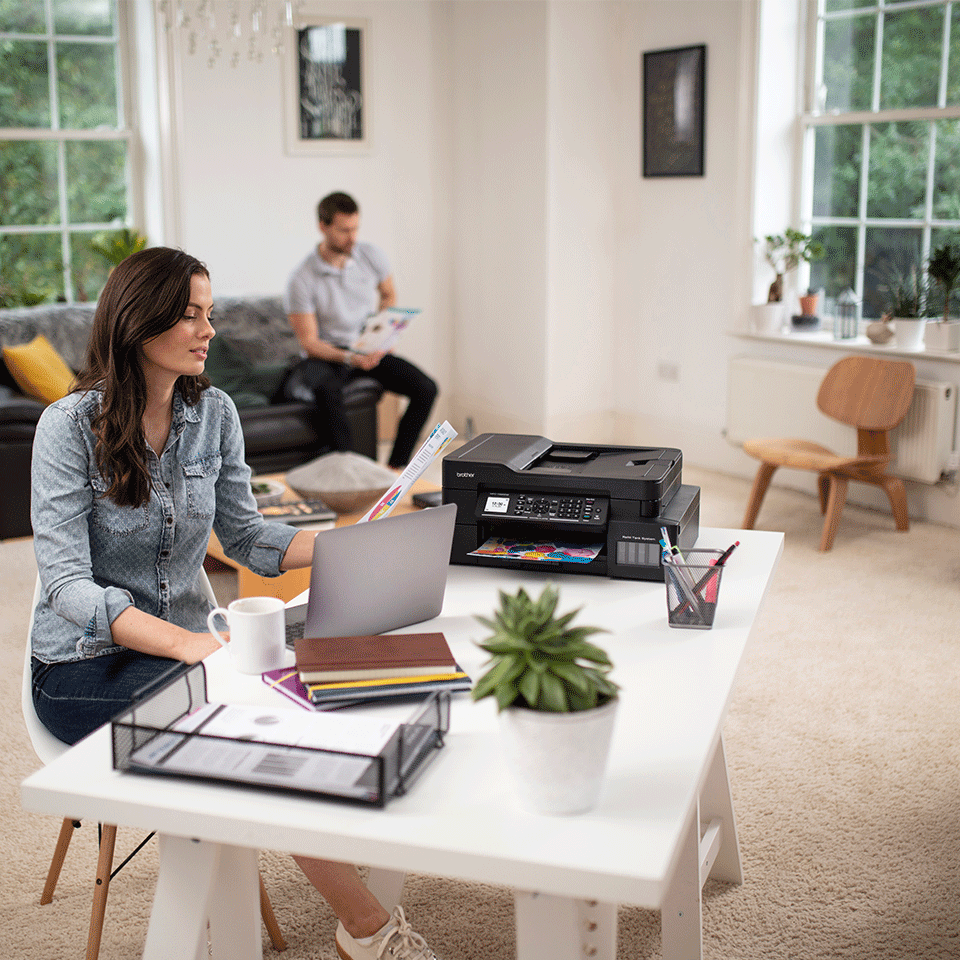 Man and woman working at home with printer visible