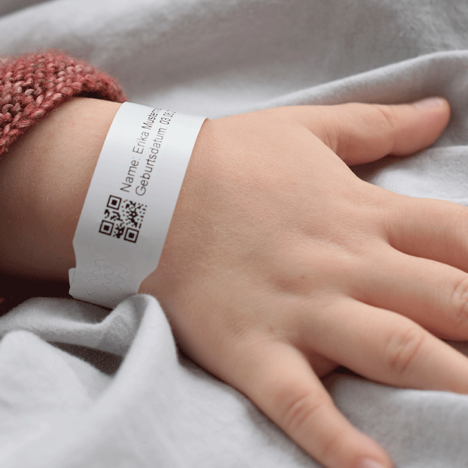 <p>child with infant wristband</p>