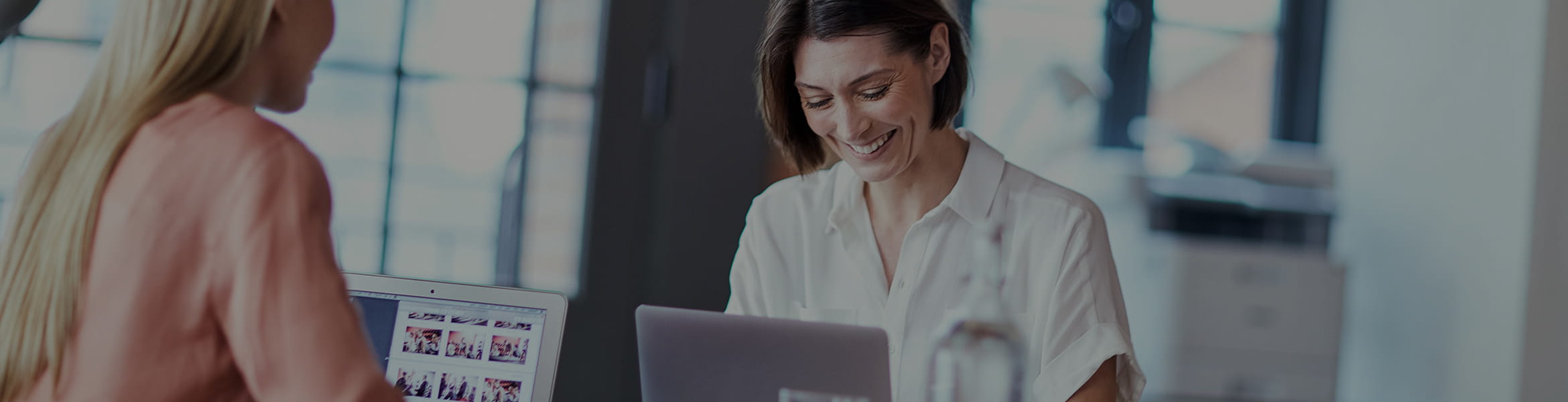 Woman working at a desk registering a Brother product