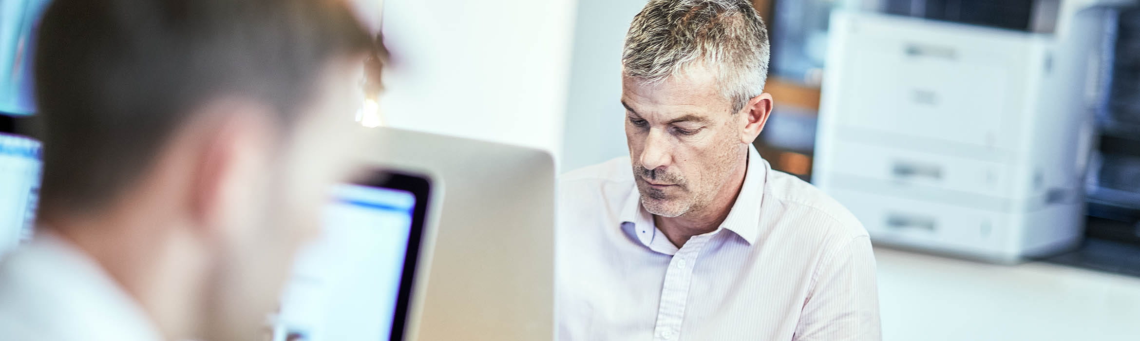 two men working on computers