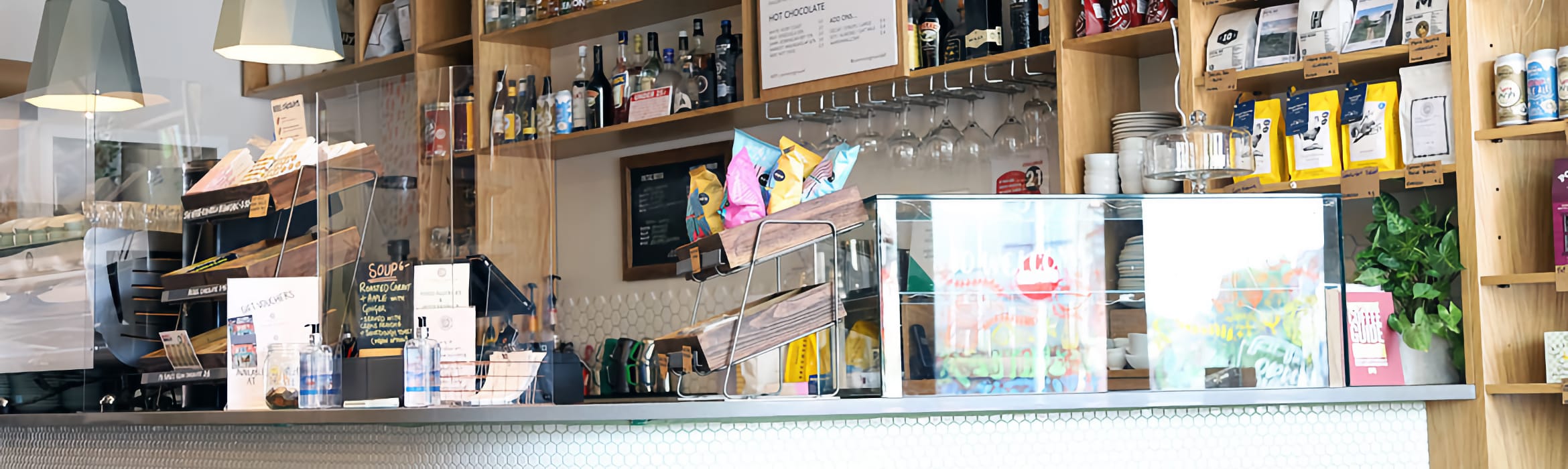 Common Ground coffee shop food and sales counter with fully stocked shelves in the background