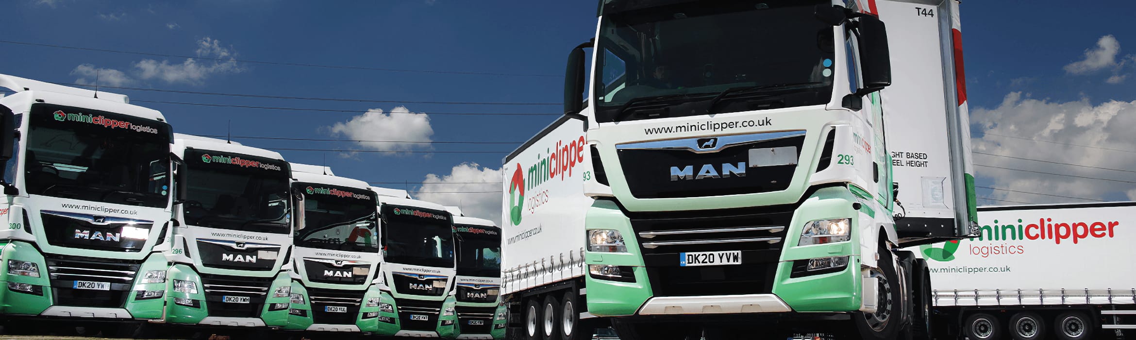 Miniclipper Logistics fleet of heavy goods vehicles with blue sky above