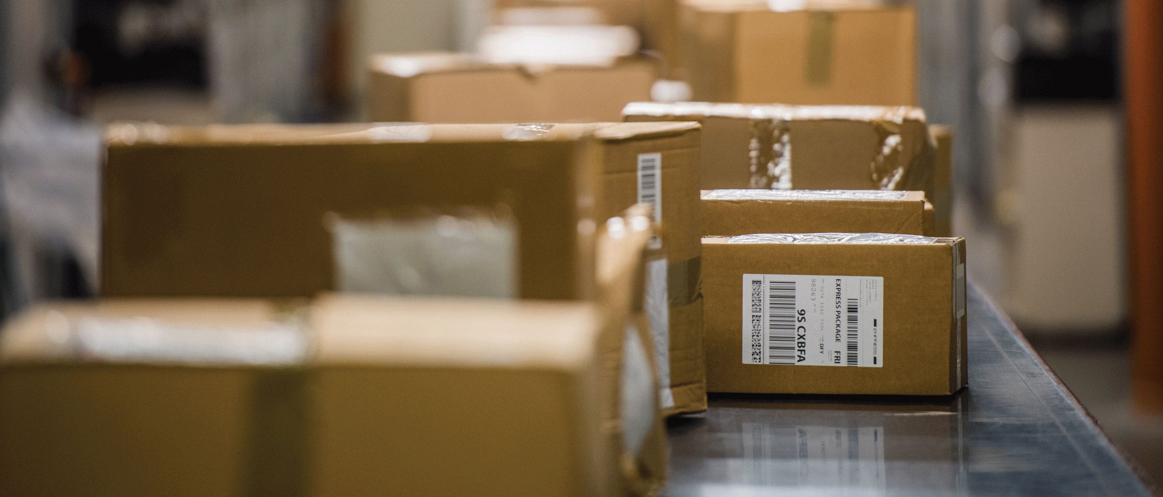 Labelled brown boxes on conveyor belt