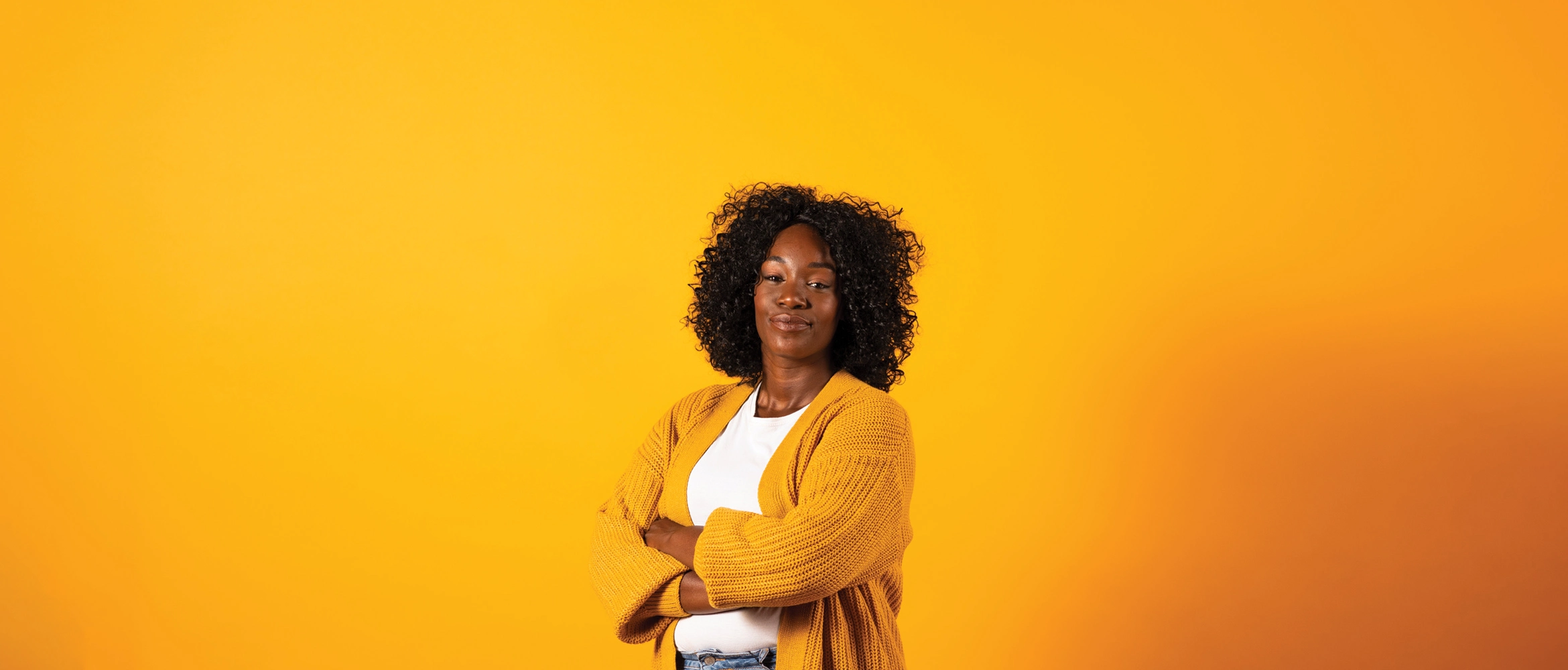 Adult female model on a plain orange background.