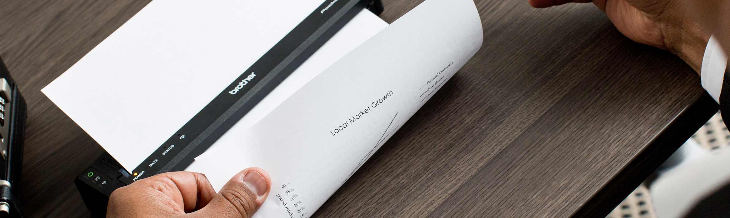 Man holding a Brother Pocket Jet mobile printer