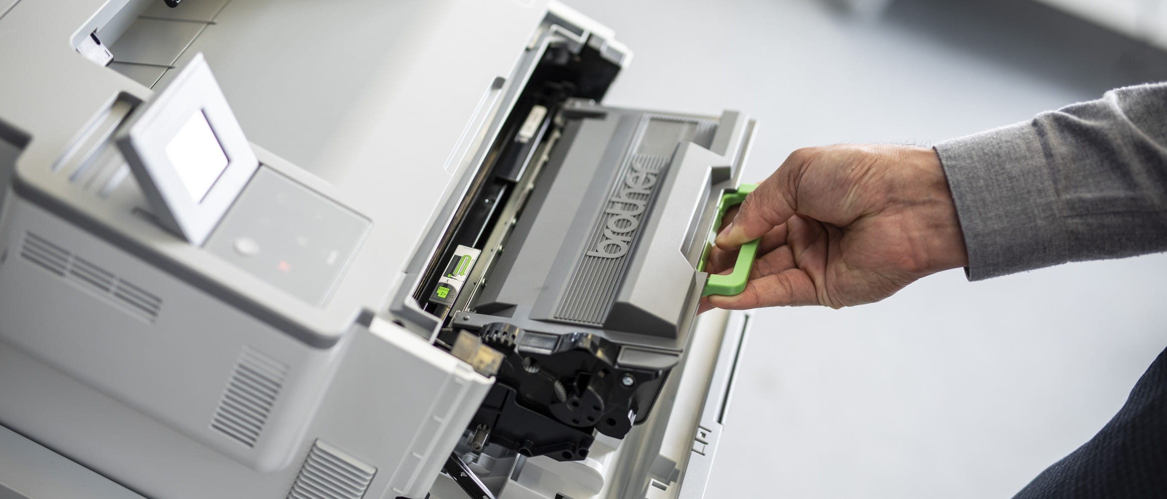 Brother laser toner print cartridge being changed on a business printer
