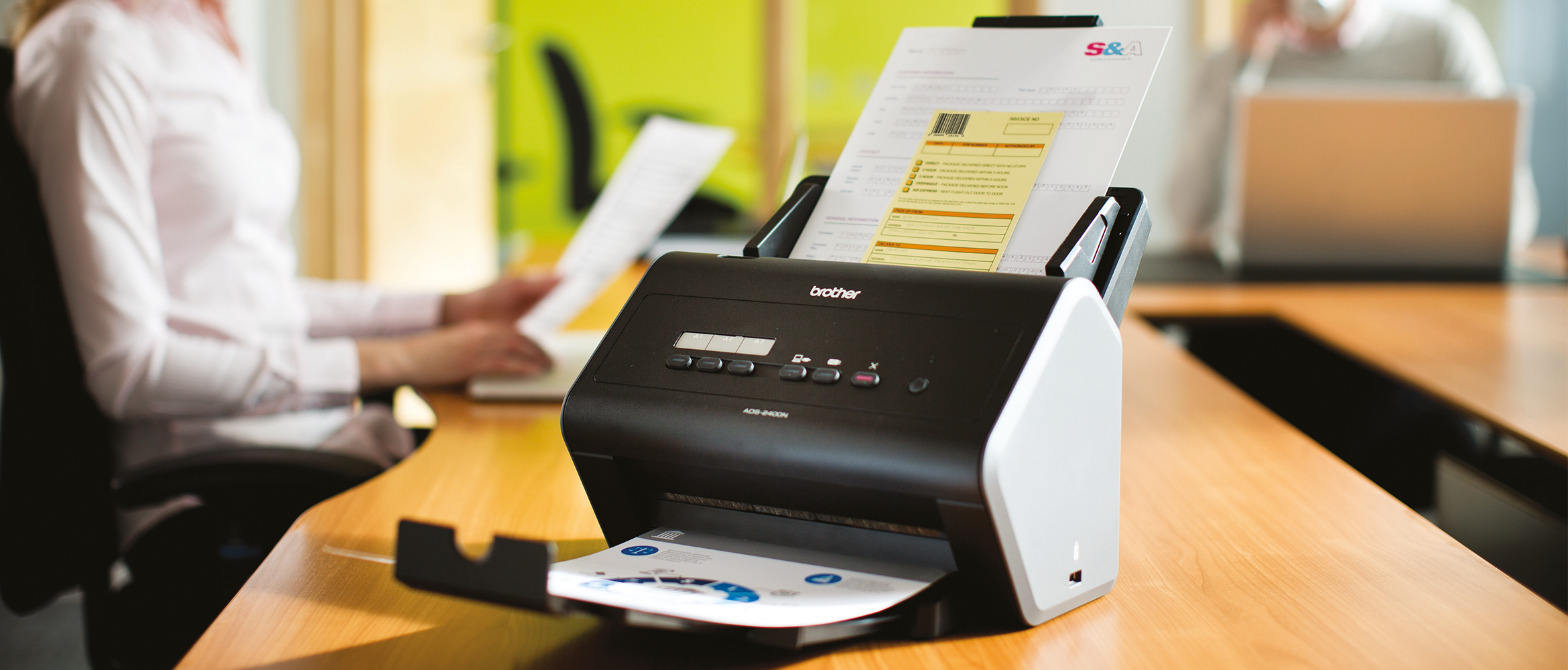 A Brother printer on a desk using the Barcode Utility upgrade