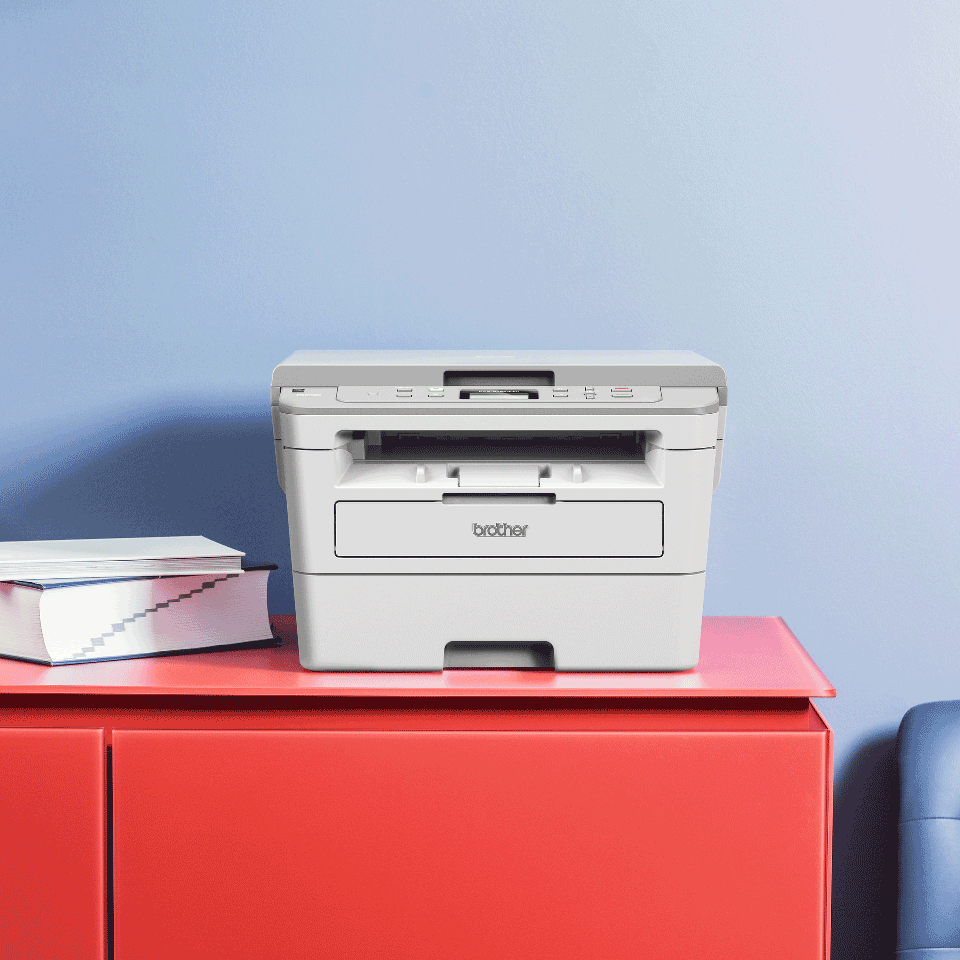 Brother DCP-B7520DW  mono laser 3-in-1 printer on a red cabinet