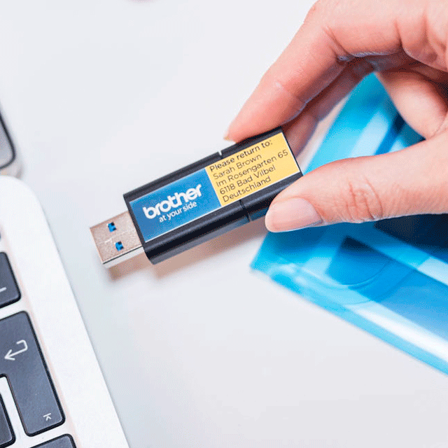 USB flash memory drive labelled with a full colour label printed on the Brother VC-500W