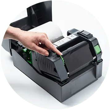 Brother TD-4T desktop label printer open with hand rolling thermal ribbon