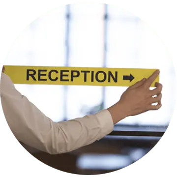 office employee sticking a reception sign to an office door