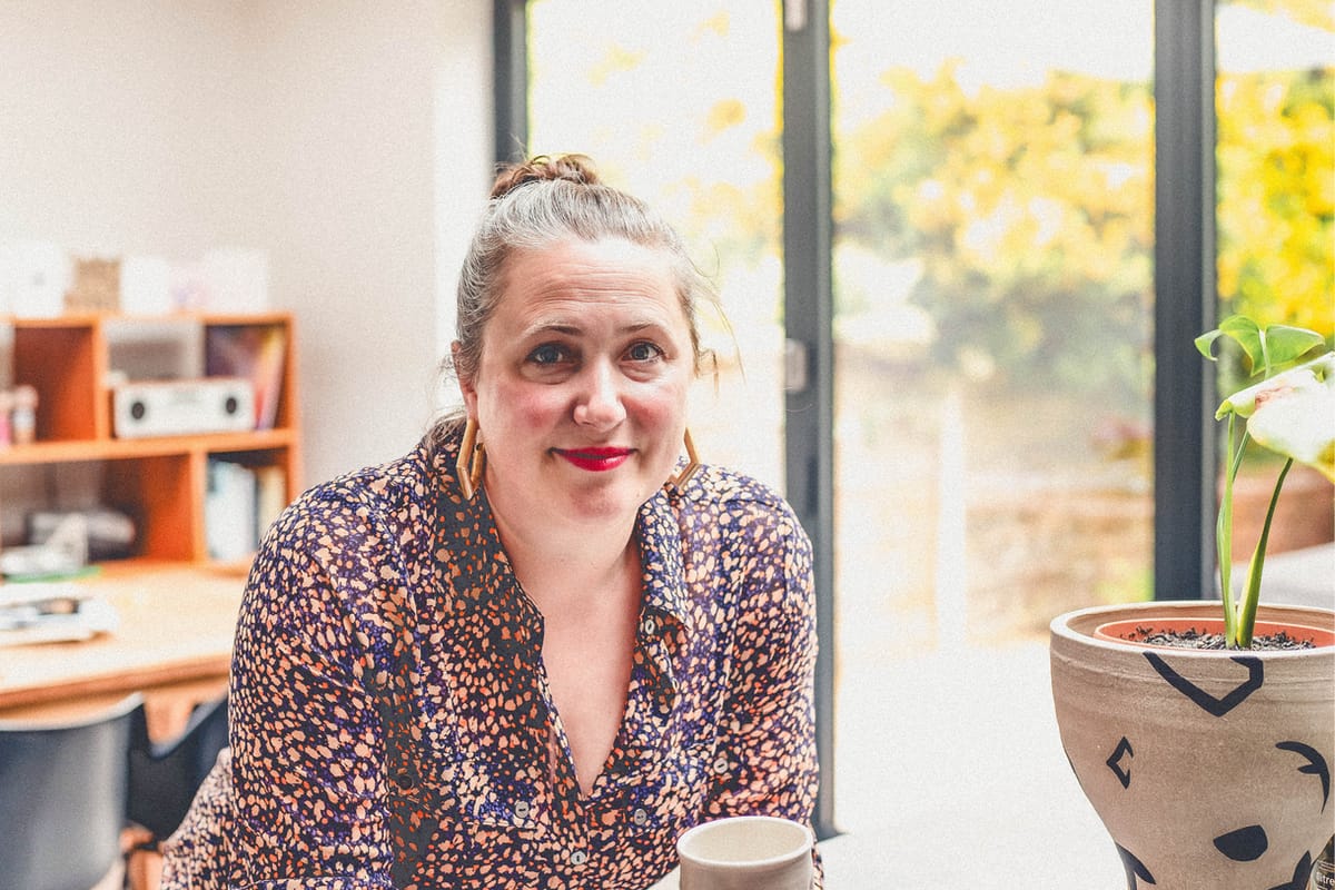 Andrea Ainsworth in her home with bi-fold doors in the background