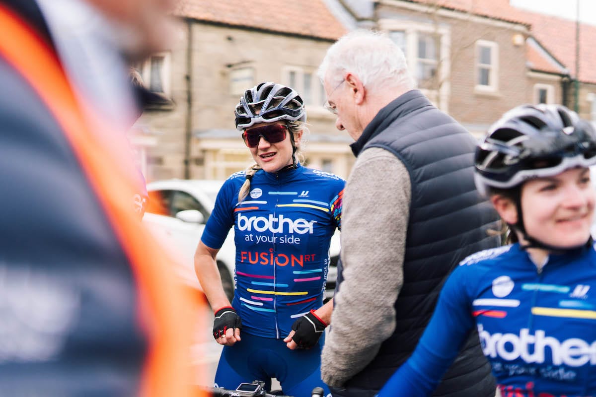 Claire Steels having a conversation with Terry Williamson among other team members