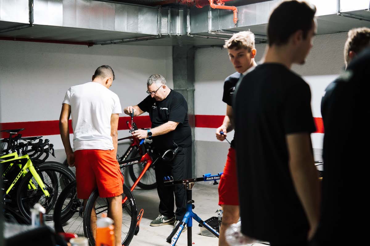 Alan Buttler in an underground hotel car park removing a bicycle wheel in preparation for transit