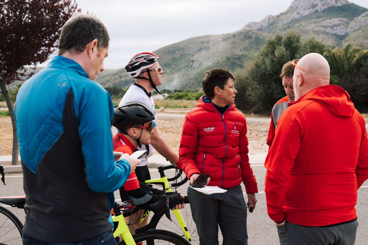 Cherie Pridham organising an ad-hoc time-trial by the roadside as Phil Jones MBE encourages the riders