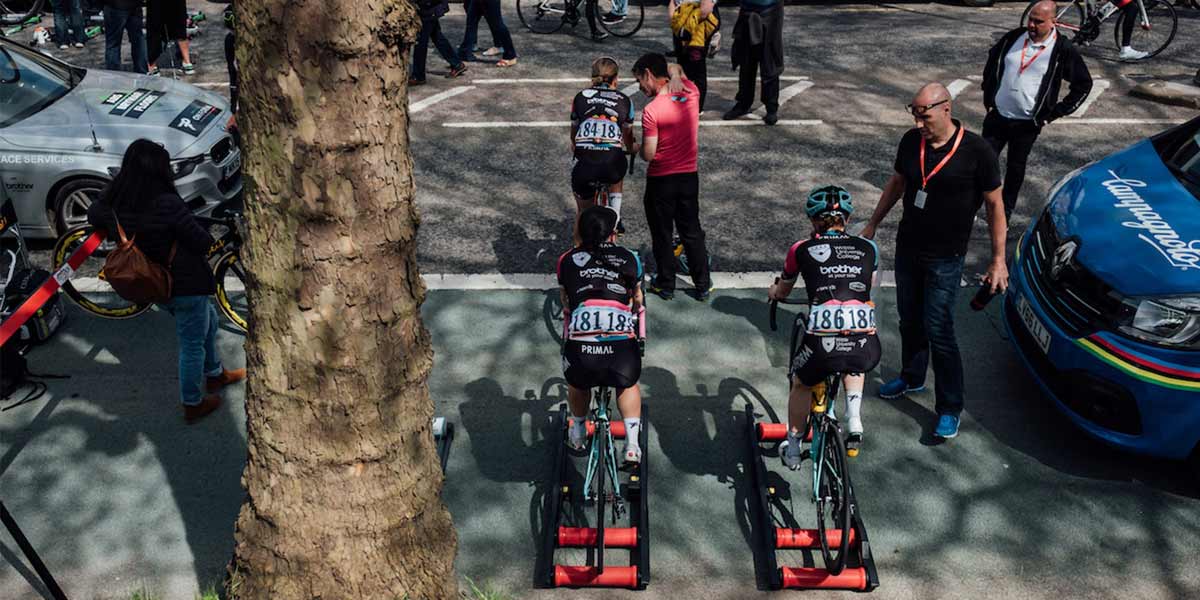 Three members of Team OnForm warming up on bikes