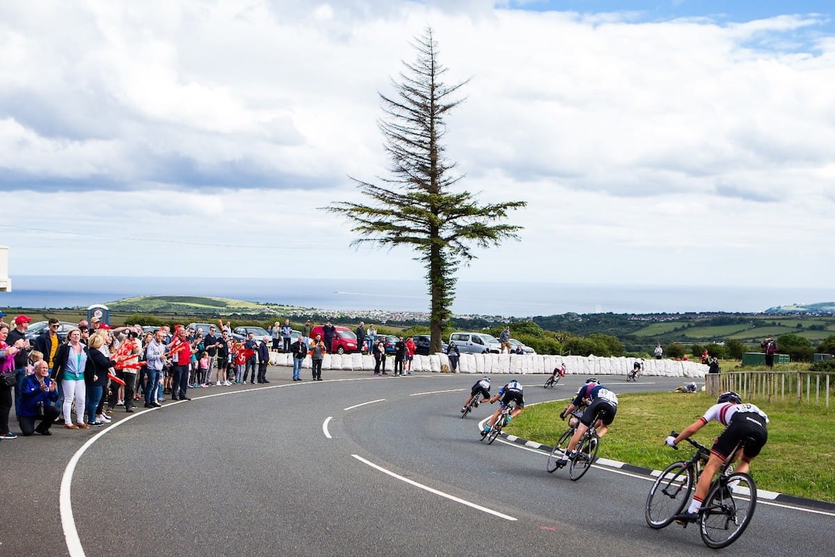 cyclists negotiate a corner in road race
