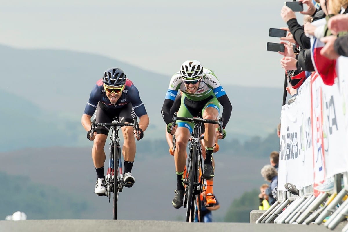 cyclists reaching the peak of a climb