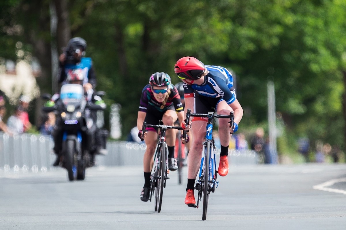 cyclist looks behind to check for competition