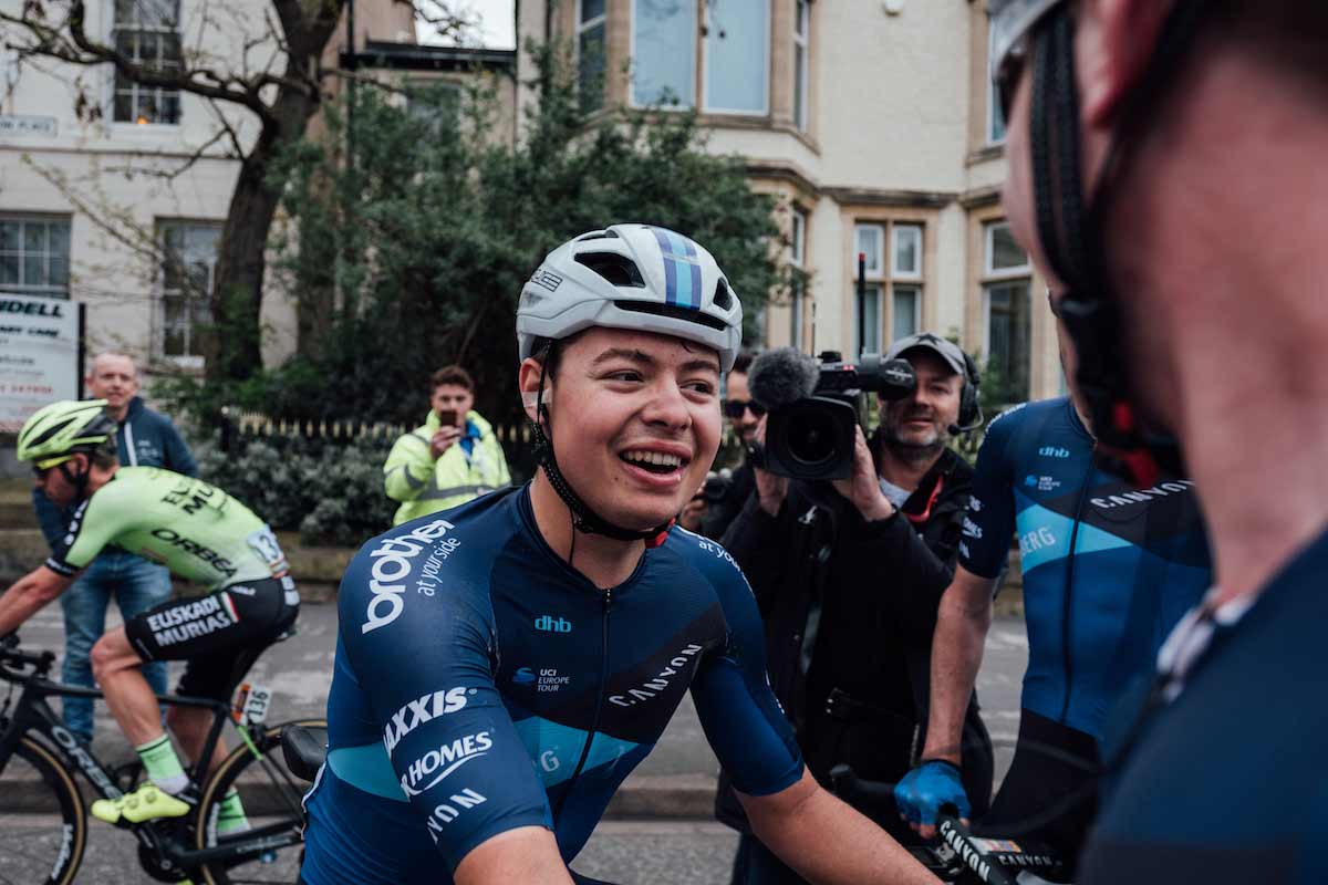 Cyclist Harry Tanfield talking to team mates