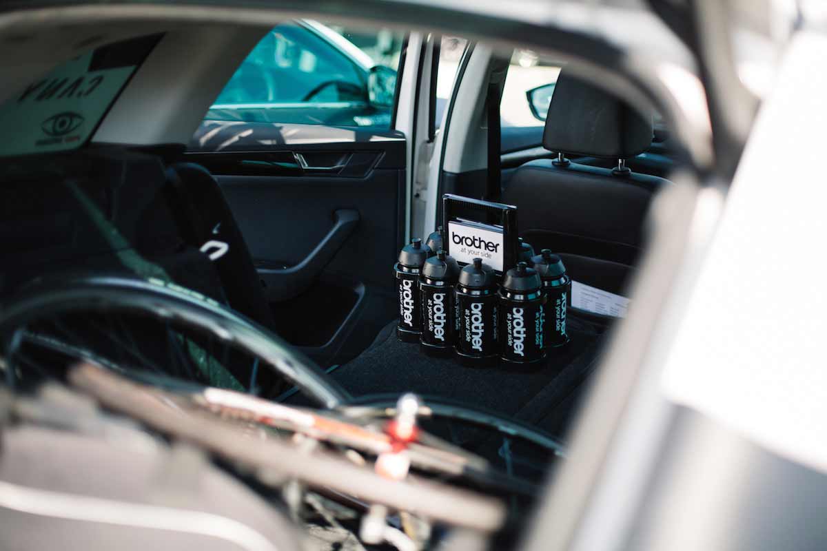 Close up of Brother branded water bottles in a support car